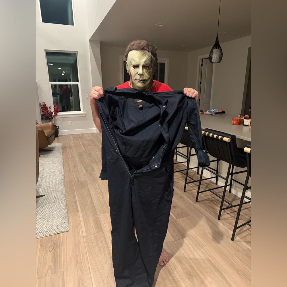 Michael Myers mask and blue jumpsuit